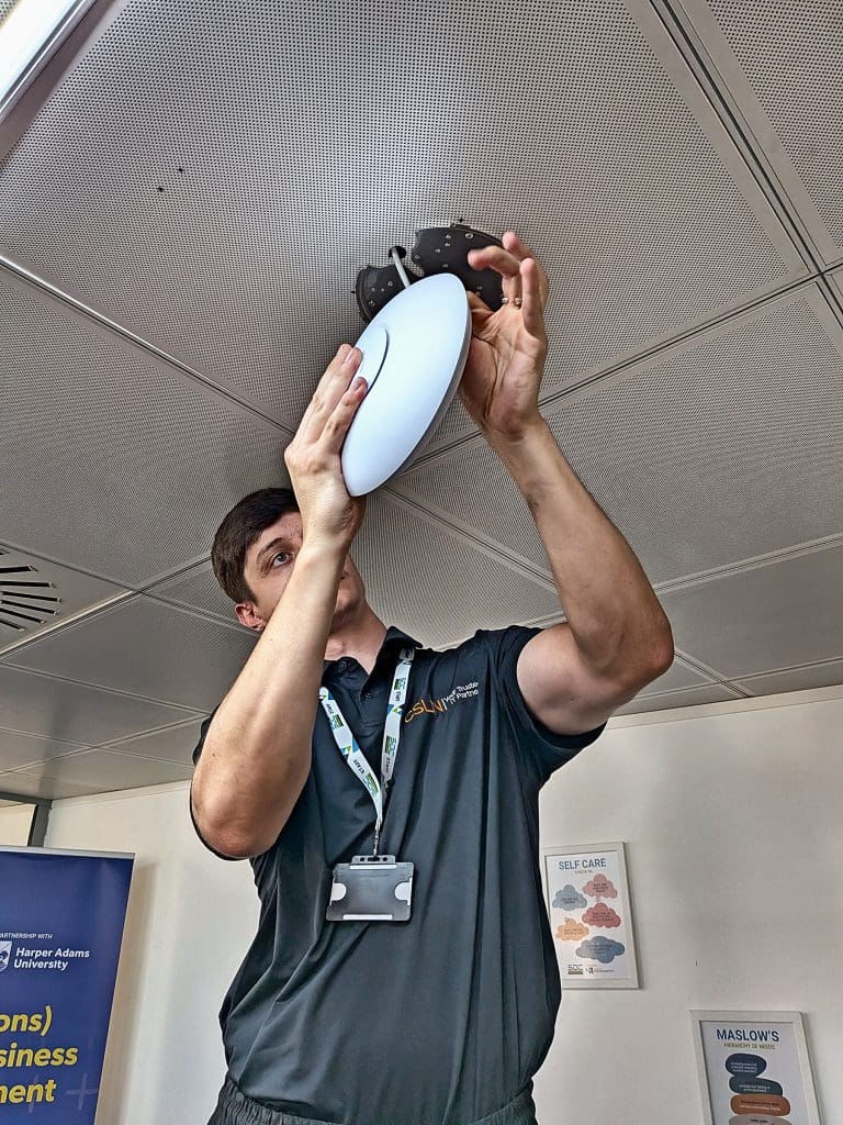 Csln-Engineer-Installing-Ubiquiti-Unifi-Ceiling-Access-Point Csln Group Engineer Fitting A Ubiquiti Unifi Wireless Access Point Into A Suspended Ceiling At A Client Site